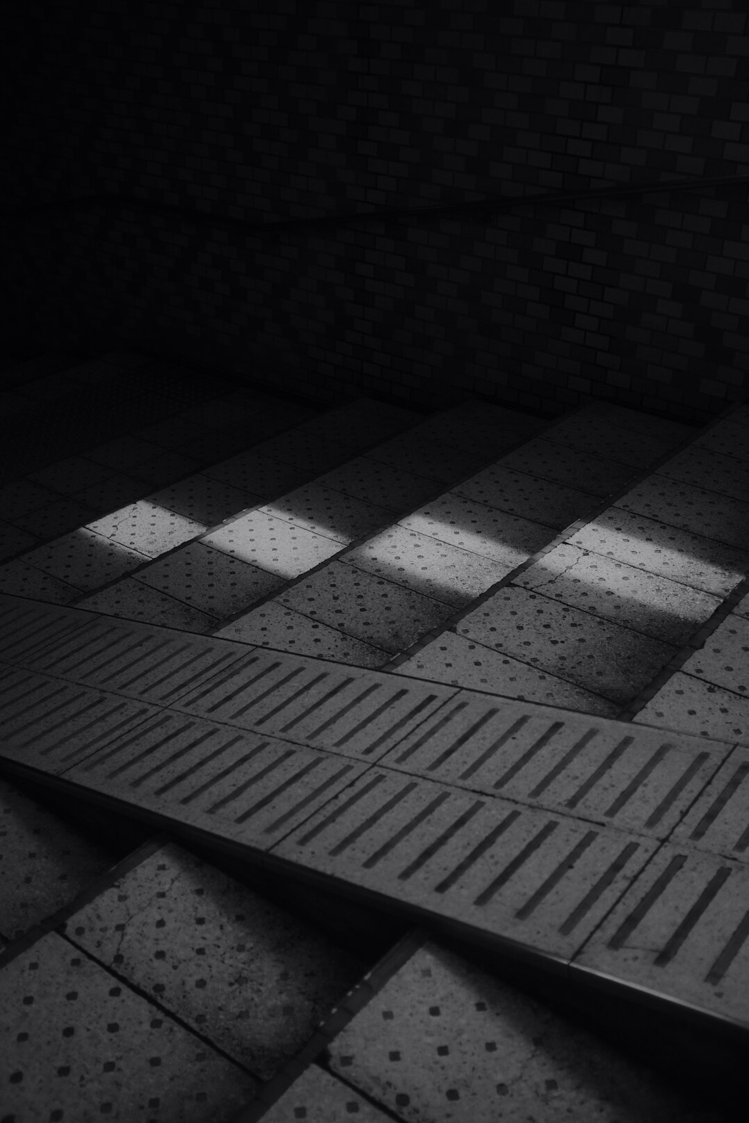 Empty television studio floor with overhead lighting grid and camera cranes