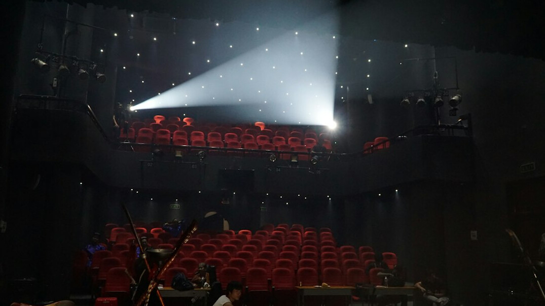 Live television show set with studio audience seating and stage lighting