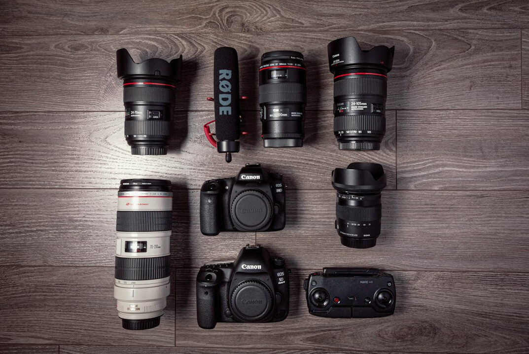 Flat lay of professional camera lenses and broadcast equipment cases