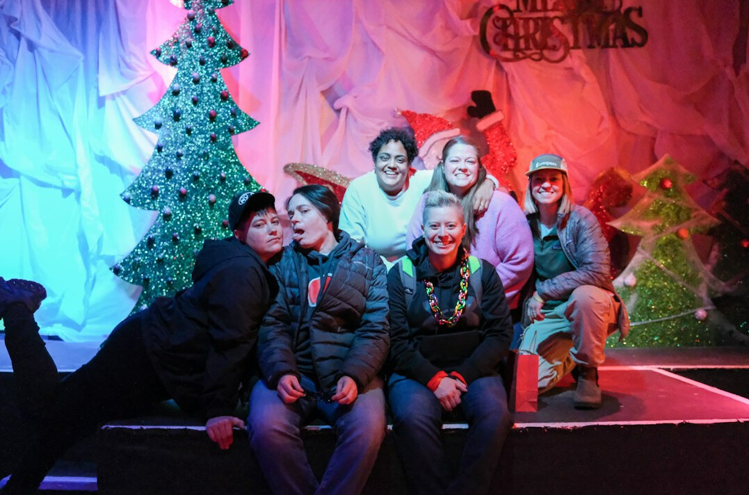 Diverse studio production crew standing together in a television studio
